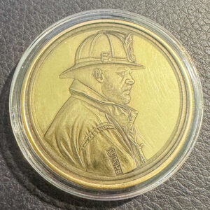 Embossed Challenge Coin with the side image of a firefighter.