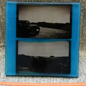 Two resin encased black and white photos
