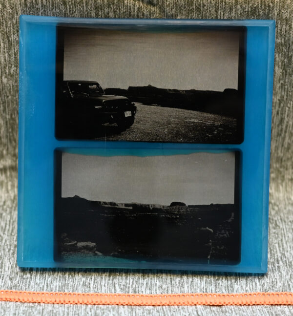 Two resin encased black and white photos